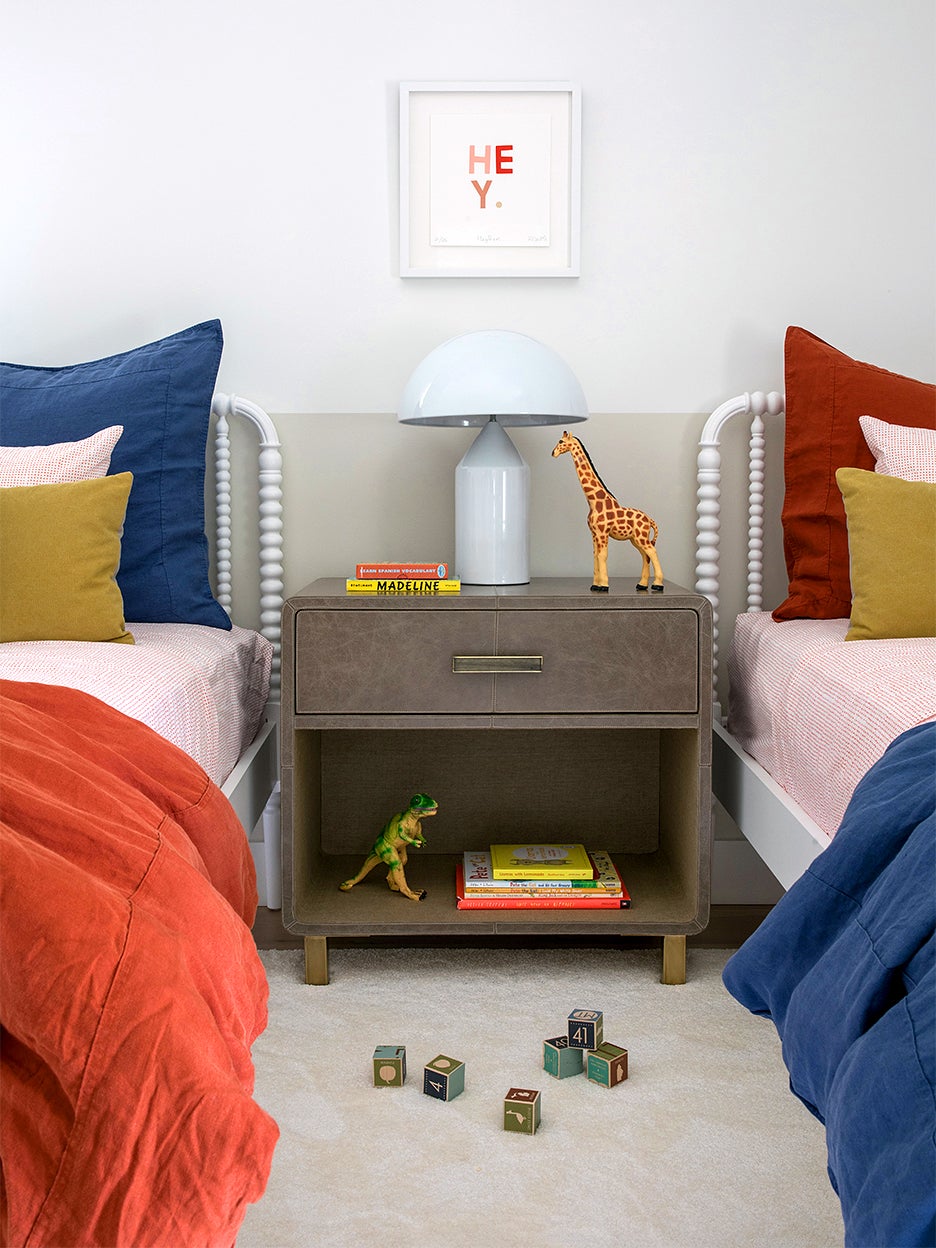 Kids bedroom with two twin beds and colorful pillows