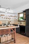 Kitchen with black cabinets and vintage butcher block