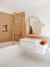 copper toned bathroom with white tile floors