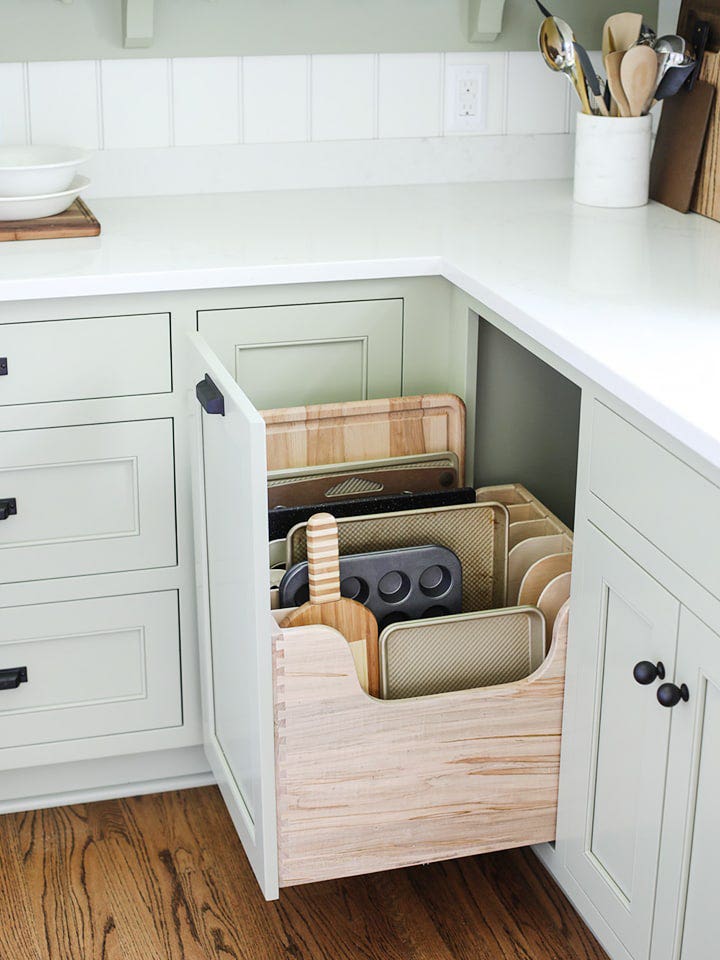 open kitchen cabinet with cutting boards inside