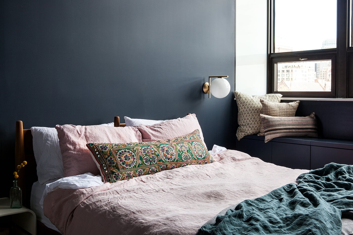 pink bed with dark accent wall
