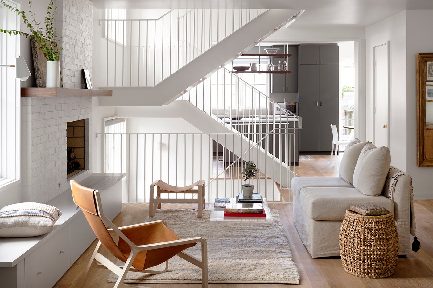 White modern staircase with gray kitchen