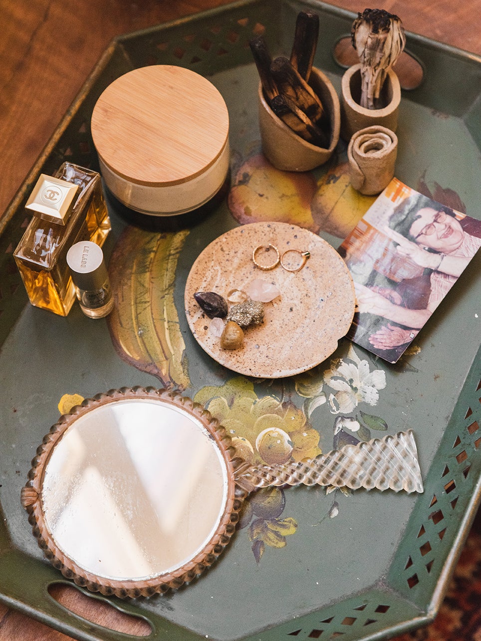 mirror and jewlery and photos on a tray
