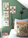 Sage green kids bedrooms - green accent wall with artwork above bed
