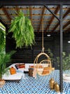 breezy outdoor sitting area under a metal roof