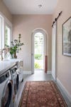 pink laundry room with arches