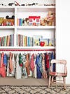 clothes hangign below bookshelf