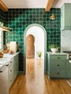 arched doorway in kitchen surrounded by green tiles