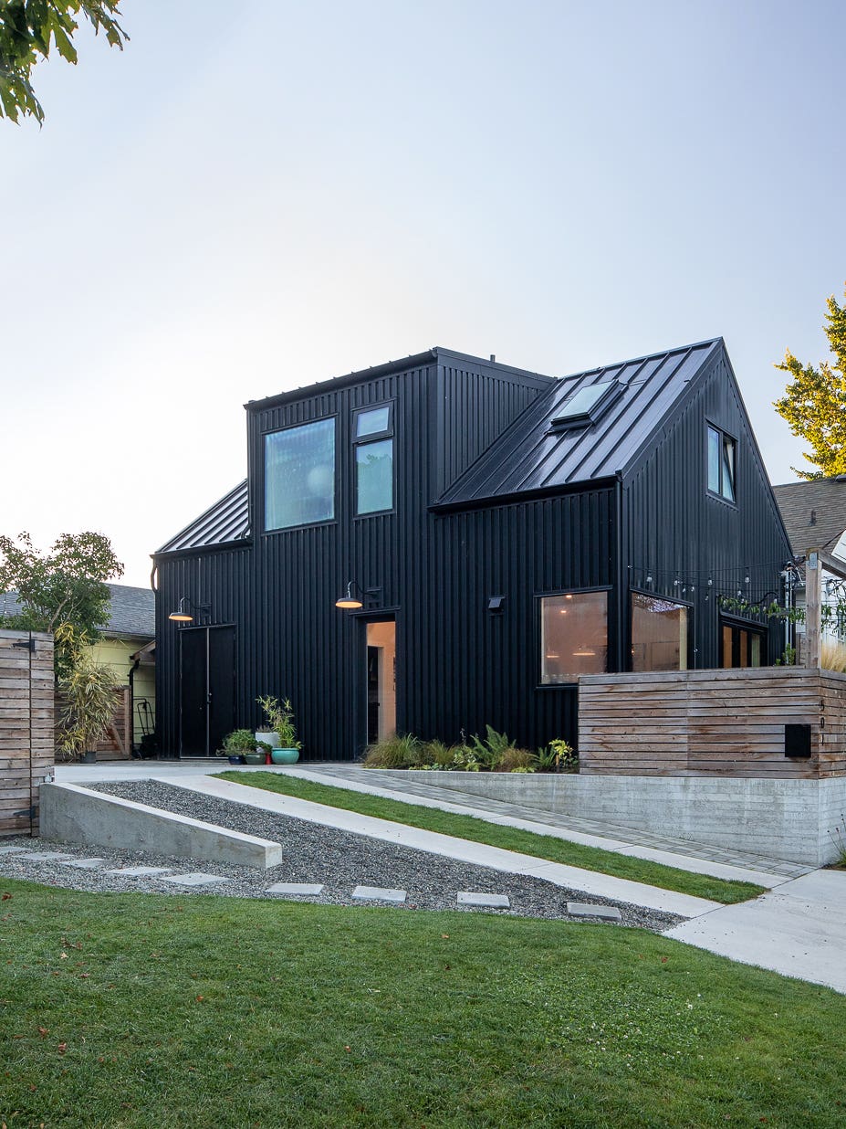 black stille house with sloped driveway