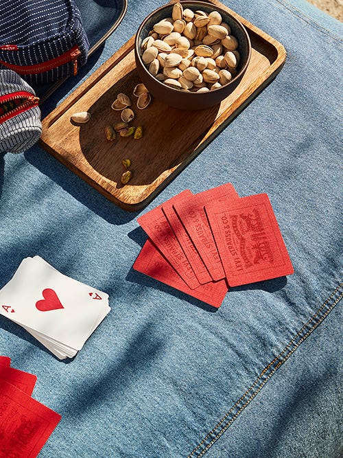 Denim picnic blanket with accessories and games on top