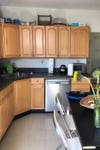 dated kitchen wiht black counters