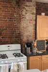 dated brick kitchen wall behind oven