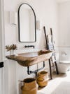 rustic bathroom with baskets and ladder