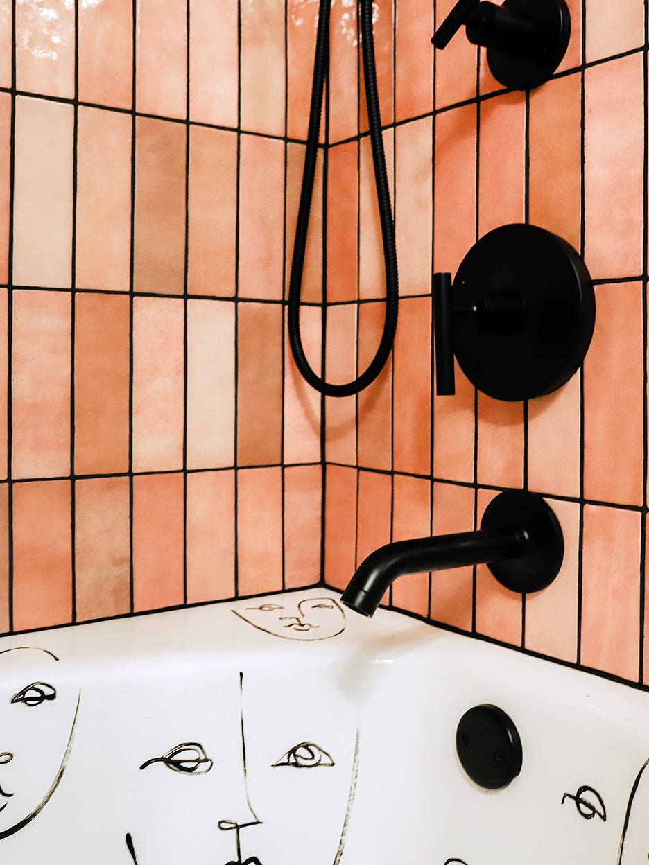 corner of pink tiled shower-tub