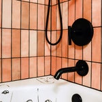 corner of pink tiled shower-tub