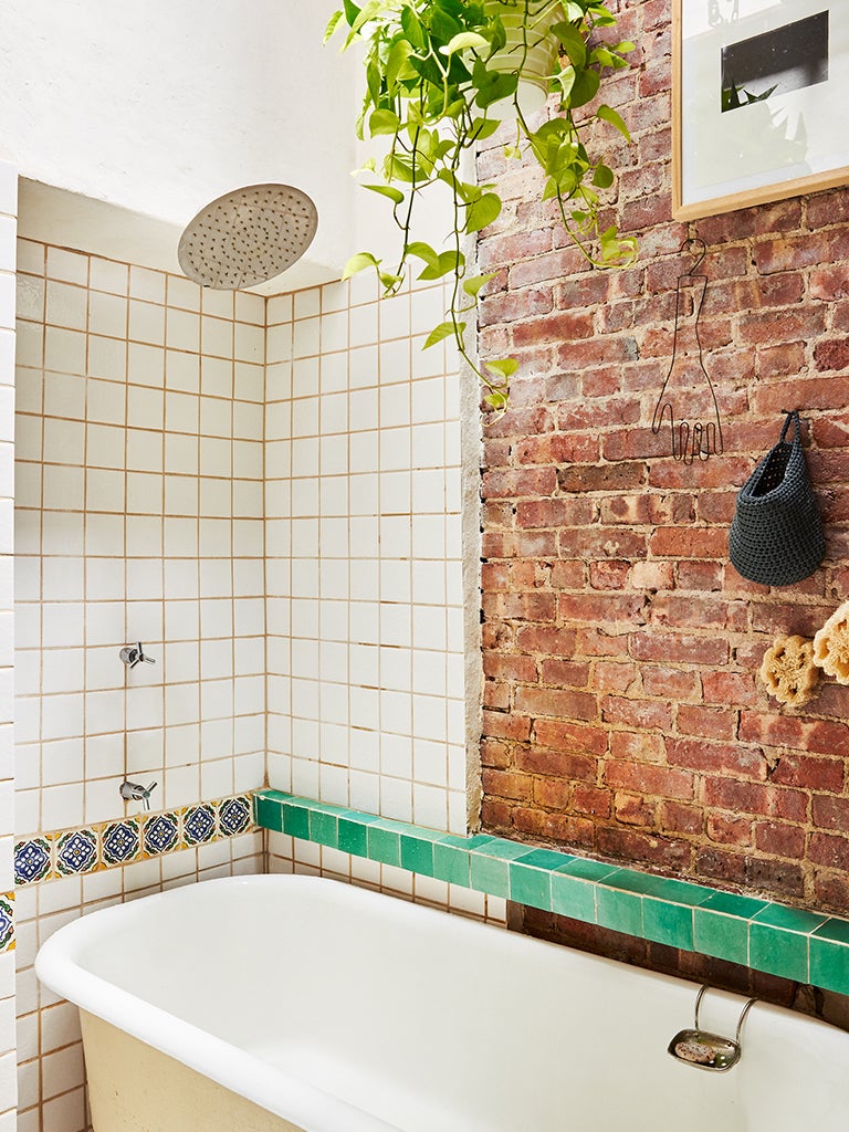 a brick accent wall in a bathroom