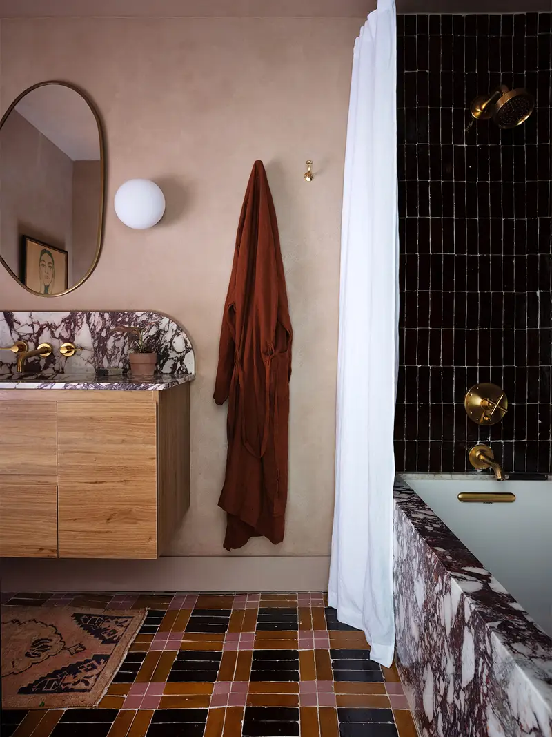 Bathroom with black, mustard- and pink plaid tile.