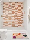 Bathroom featuring geometric patterned tile in white and terracotta colors.