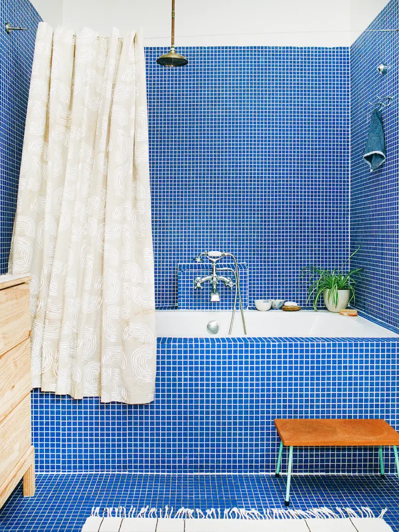 Bathroom covered in cobalt blue mosaic tile.