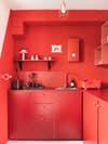 bright red tiny apartment kitchen
