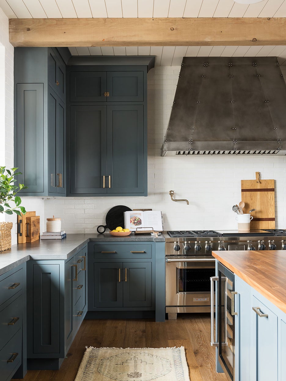 green blue kitchen with metal vent hood