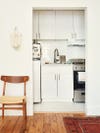 tiny white apartment kitchen