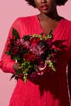 woman holding red bouquet