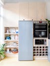 blue fridge in light wood kitchen