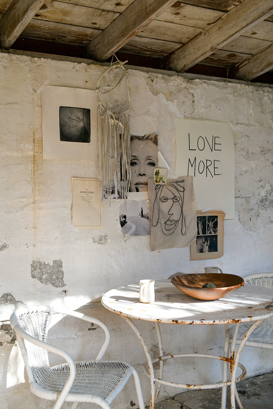 white chairs with collage art on wall