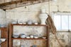 pottery drying on shelves