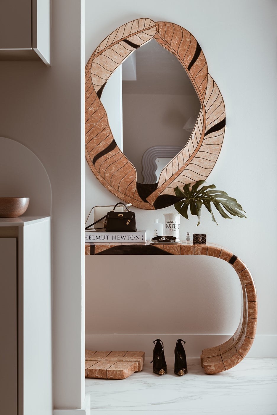rosy stone console table and matching leaf mirror