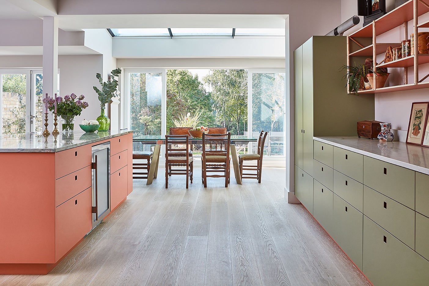 pink and green kitchen open to dining room