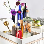 tray of cocktail tools in colorful vessels