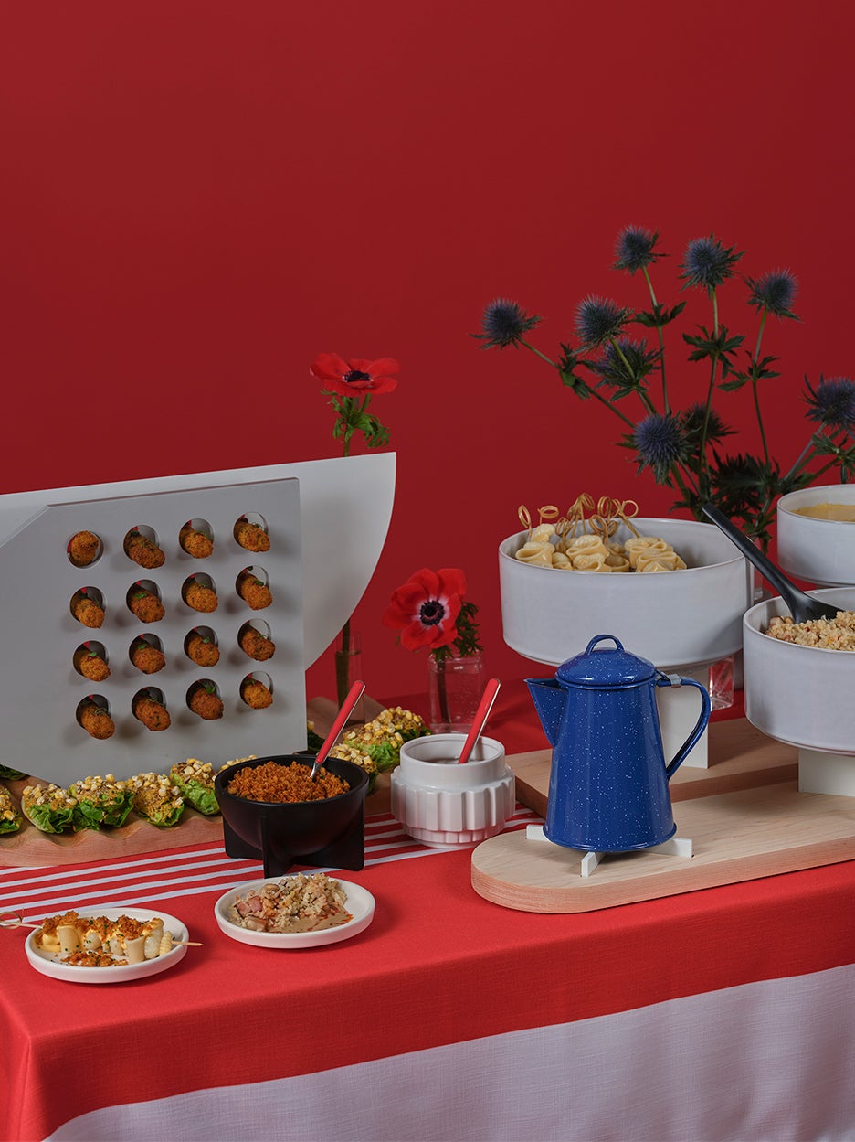 appetizers on sculptural displays in red room