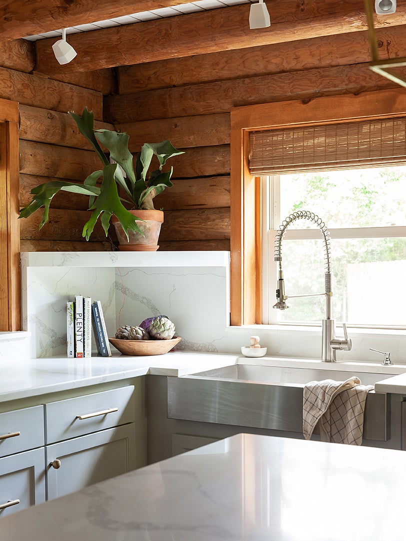 corner of gray kitchen with raw wood siding on walls