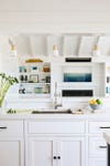 white kitchen overlooking shiplap living room