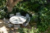 round outdoor table and chairs in garden