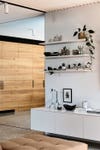 white wall with floating shelves and pottery