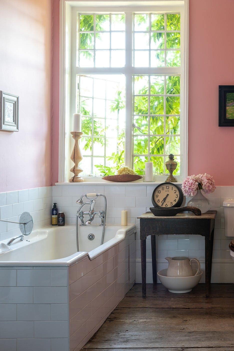 bubblegum pink bathroom with white tiled tub
