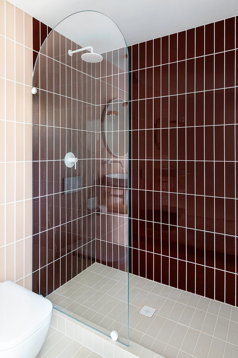 shower with burgundy and pink tile