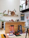 wood kitchen with colorful striped stools
