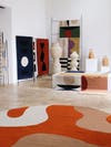 studio space with swirly orange rug