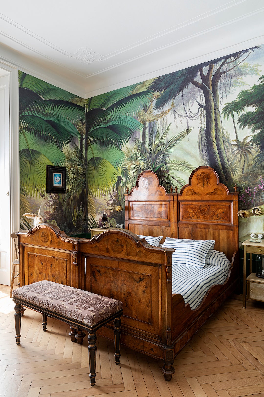 Vintage bed with mural of a jungle