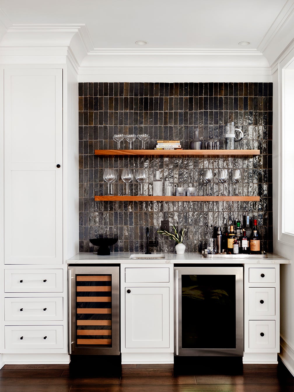 Bar with wooden shelving and black tile