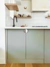 gray lower kitchen cabinet with half moon pull