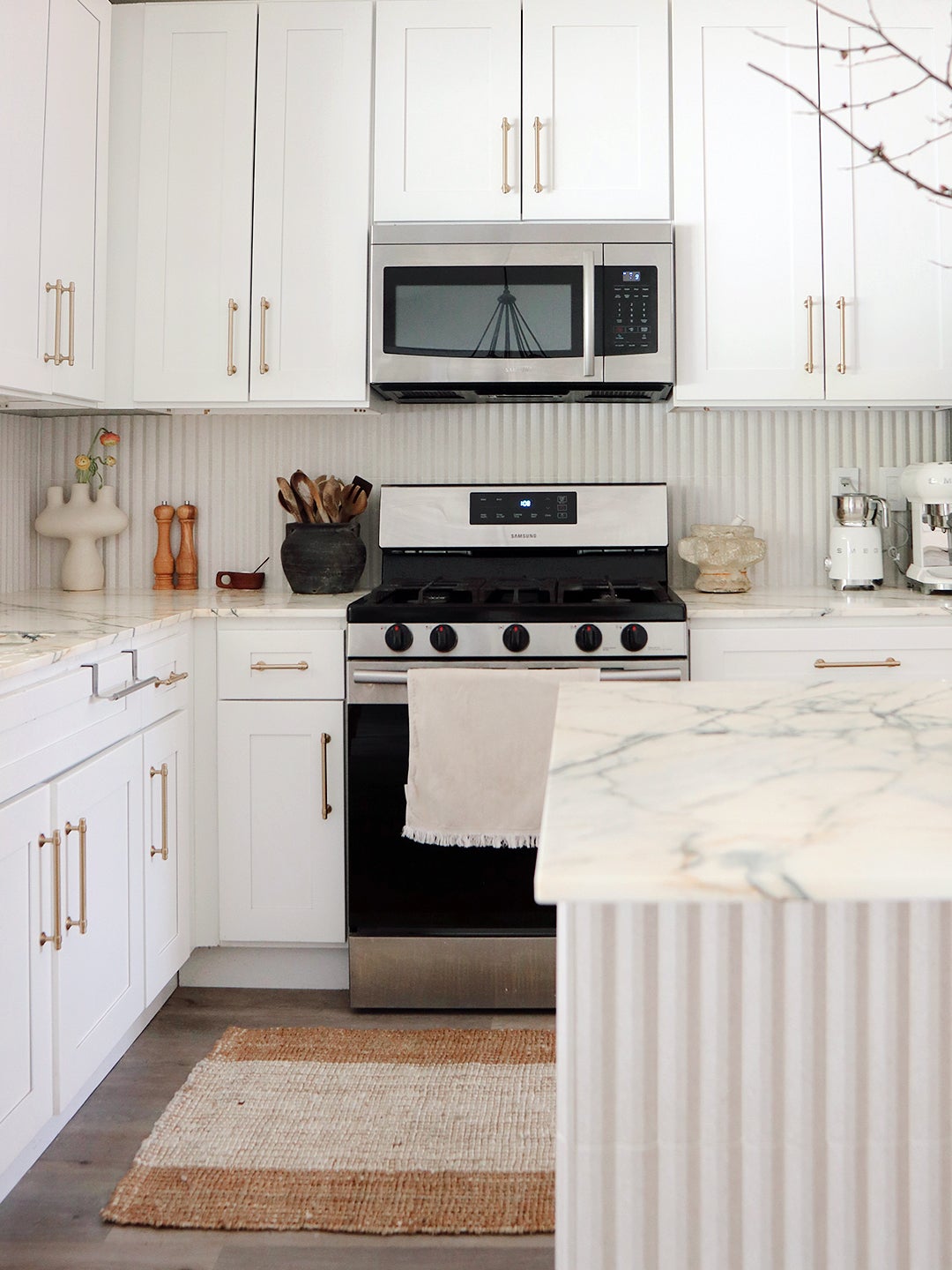white kitchen with fluted island