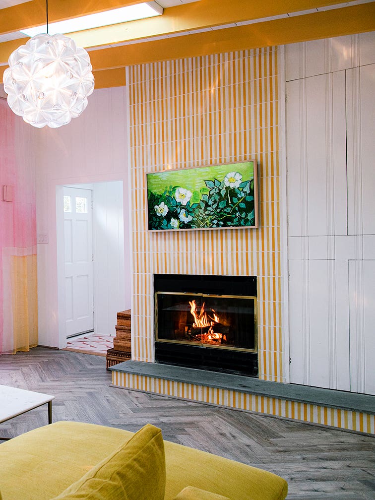 Living room with rainbow curtains and a yellow sofa