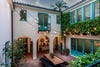 Courtyard of a Spanish Colonial-style home with aquamarine doors
