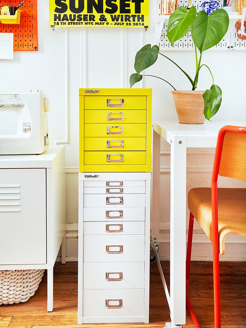 Yellow cabinet stacked on top on a white cabinet in home office
