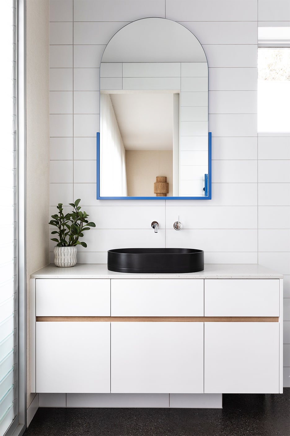white bathroom vanity with black sink